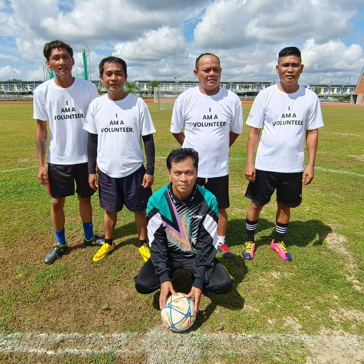 Volunteers cheering at Special Olympics event, wearing matching shirts